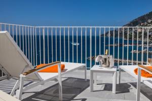 a balcony with a table and chairs and the ocean at Hotel Marina Riviera in Amalfi