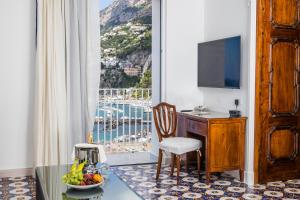 a room with a desk and a window with a view at Hotel Marina Riviera in Amalfi