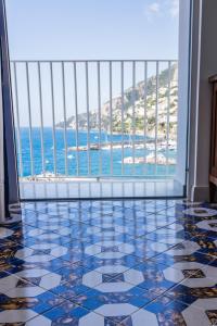 a room with a tile floor and a view of the ocean at Hotel Marina Riviera in Amalfi