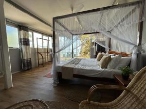 a bedroom with a large bed with a canopy at Kenno's Korner in Weligama