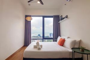 a bedroom with a bed and a large window at Tropicana 218 Macalister Penang in George Town