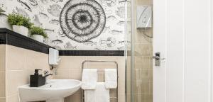 a bathroom with a sink and a toilet and a shower at Fisherman Cottage Llanfaes near Beaumaris in Llanfaes +21 photos