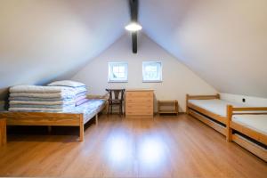 a attic room with two beds and a desk at Chalupa Morávka 2 v Beskydech in Morávka