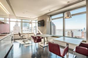 a kitchen and dining room with a view of the city at Studio in Tribeca w gym lounge roof deck NYC-1373 in New York