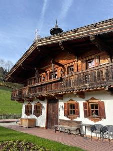 a wooden building with a bench in front of it at Chalet Nestwärme in Reith bei Kitzbühel