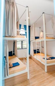 a room with three bunk beds in it at MONTANA HOMESTAY VUNG TAU in Vung Tau