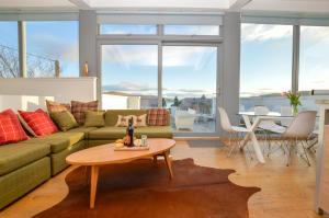 a living room with a couch and a table at Old Fire Station in Tighnabruaich