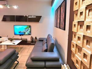 a living room with a couch and a tv at Center Apartment Easy_Luxury in Tirana