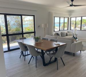 a living room with a table and a couch at Beach House Yeppoon - ARay at Cooee Bay - Apt A in Yeppoon