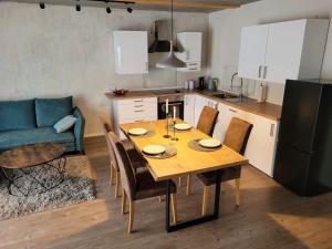 a kitchen and dining room with a table and a couch at Wohnung unterm Burghalder - Direkt am Waldrand in Hauenstein