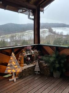 a porch with a christmas display of trees and lights at Kiczurka Bieszczady in Baligród