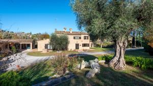 an old house with a tree in front of it at VILLA ISOTTA 8&4, Emma Villas in Civitanova Marche