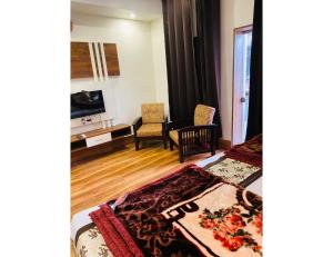 a room with two beds and a living room at Hotel Sita Niwas Since 1965, Amritsar in Amritsar