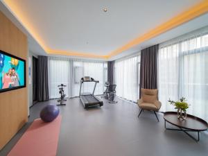 a room with a gym with a treadmill and a tv at Park Inn by Radisson Chengdu Wuhou Shrine in Chengdu