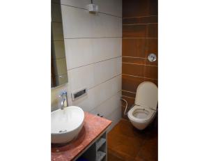 a bathroom with a sink and a toilet at Hotel Sita Niwas Since 1965, Amritsar in Amritsar
