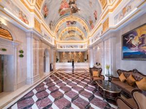 a large room with a ceiling with paintings on the walls at Vienna International Hotel Foshan Lecong Center in Shunde