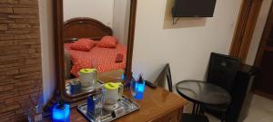 a room with a desk and a bed with a mirror at Vila Magica in Constanţa