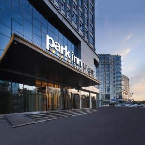 a building with a sign on the front of it at Park Inn by Radission Tianjin Binhai International Airport in Tianjin