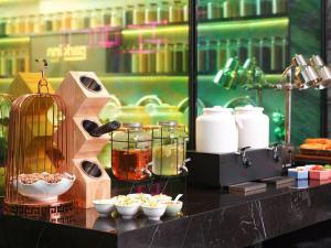 a counter with bowls and jars of food on it at Park Inn by Radisson Hanzhong Central Square & High speed rail station in Hanzhong