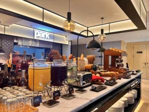 a bakery with a counter with some food and drinks at Park Inn by Radisson Chengdu FengHuang Mountain Sports Park in Xindu
