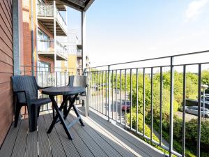 a balcony with a table and chairs on a building at Pass the Keys Free Parking and Walking Distance Etihad Coop Arena in Manchester