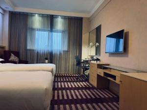 Postel nebo postele na pokoji v ubytování Park Inn by Radisson Shanghai Downtown