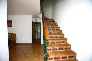 a staircase in a house with a green railing at Casa Rural El Bosque in El Bosque
