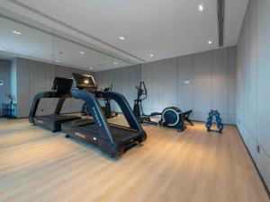 a gym with two exercise bikes and a treadmill at Park Inn by Radisson Jilin Beishan Park&Songhua River in Jilin
