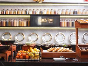 a buffet with bread and other food on display at Park Inn by Radisson Hanzhong Central Square & High speed rail station in Hanzhong