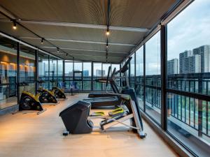 a gym with treadmills and exercise equipment in a building at Park Inn by Radisson Chengdu Sihe Metro Station Xinchuan in Chengdu