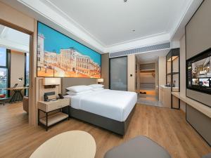 um quarto com uma grande cama branca e uma televisão de ecrã plano em Vienna International Hotel Chengdu Shuangliu Airport Terminal Beijing Hualian em Chengdu