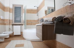 a bathroom with a tub and a toilet and a sink at VILLA MARTINA PIA B&B in Filiano +17 photos