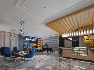 a rendering of a hotel lobby with a piano at Park Inn by Radisson Tianjin Jinghai Wanda Plaza in Jinghai