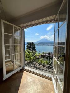 a room with a large window with a view of the water at Charming house with a lake view in Lucerne