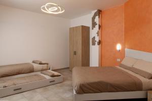 a bedroom with two beds and a closet at VILLA MARTINA PIA B&B in Filiano