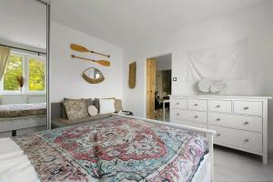 a bedroom with a large bed and a mirror at Elite Apartments Cozy Studio Sopot in Sopot