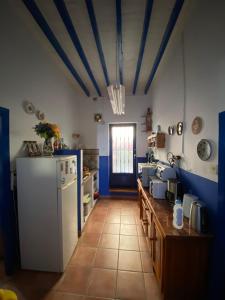 eine Küche mit einem weißen Kühlschrank und blauen Decken in der Unterkunft Casa en Alcazaba in Almería