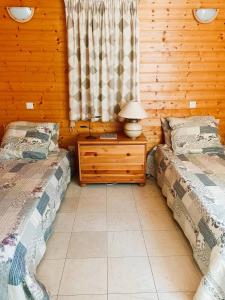 - une chambre avec deux lits et une table avec une lampe dans l'établissement GASPRO16 - Golfe de Saint-Tropez - Chalet californien climatisé, à Gassin