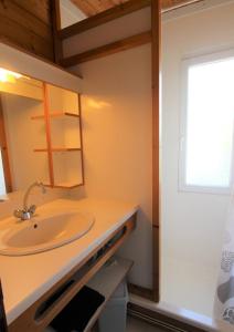 La salle de bains est pourvue d'un lavabo et d'un miroir. dans l'établissement GASPRO16 - Golfe de Saint-Tropez - Chalet californien climatisé, à Gassin