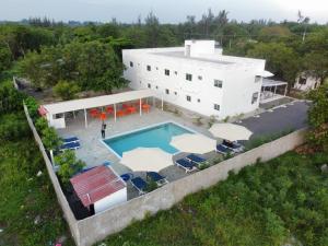 an aerial view of a house with a swimming pool at Butah Gardens Watamu in Gede