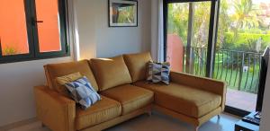 a couch in a living room with pillows on it at Vera Playa Naturista Michel in Vera