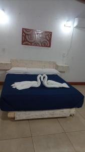 a bed with swans on it in a room at POSADA DE LA LUNA in Ciudad Lujan de Cuyo