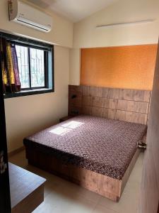a bedroom with a bed in a room at 2bhk Apartment with 1900sq ft Private Terrace in Lonavala in Malavli