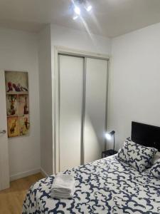 a bedroom with a bed with a pillow on it at Plaza Rio B in Madrid +8 photos