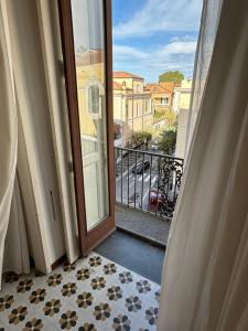 an open door to a balcony with a view of a street at Angel's Home in Sorrento