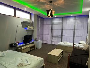 a room with two beds and a green light at KENT hotel & Restaurant KENT beach in K'obulet'i
