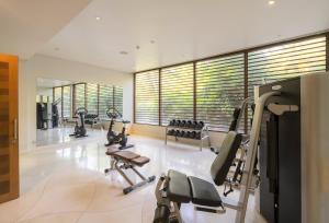 a gym with treadmills and ellipticals in a room at The Shells Resort & Spa Phu Quoc in Phú Quốc