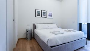 a white bed with two towels on top of it at Italianway - Cecchi 18 in Milan