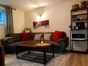 a living room with a couch and a coffee table at Eulennest im Souterrain in Elten