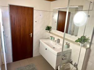 y baño con lavabo y espejo. en Ferienwohnung SeeLiebeee, en Friedrichshafen